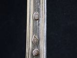 a close up of a spoon on a table with a black background