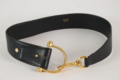 black leather belt with a gold buckle on a white background