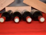 several bottles of wine are lined up in a row on a table