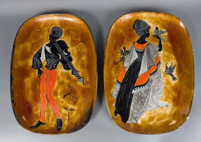these are two decorative plates with black and orange designs on them
