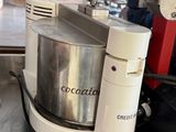a bowl of food on a counter next to a blender and a cup of coffee