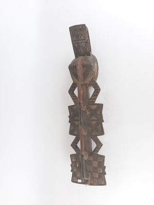 an image of a wooden sculpture of a person holding a knife