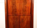 an image of a wooden cabinet with a mirror above it