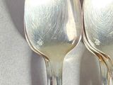 two spoons that are sitting on a table