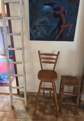 a ladder leaning against the wall next to a chair