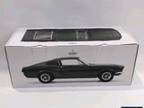 a black car in a box on a white surface