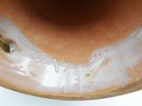 a close up of a vase with a handle on it