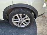 a close up of a car ' s tire on a gravel road