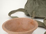 a bag and a bowl sitting on a table