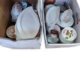 two boxes that have plates and bowls in them