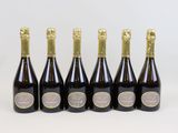 six bottles of champagne are lined up in a row