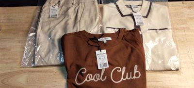 three shirts that are sitting on a wooden table