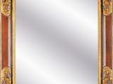 an ornate gold framed mirror on a black background