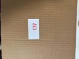 a cardboard box with a sticker on it sitting on the floor