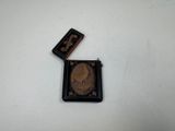 a small coin and a lighter sitting on a table