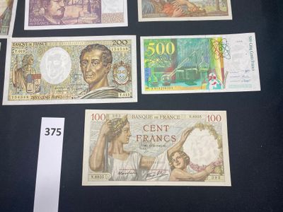 several different bank notes are displayed on a table with a price tag
