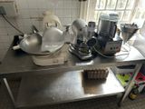 a table with a mixer, a blender, and other items on it