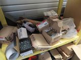 many boxes of screws on a shelf in a room