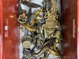 a red box with a bunch of gold items in it