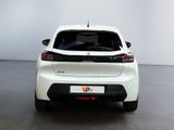 the rear end of a white car in a room with a white wall