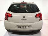 a white car that is parked in a white room