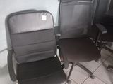three office chairs in the corner of a room