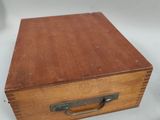 a small wooden box with a handle on a table