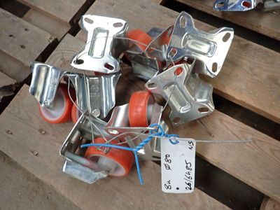 many pieces of metal and orange wheels on a pallet