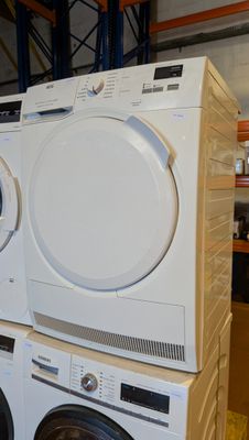 a stack of washers and dryers stacked on top of each other