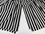 black and white striped pants hanging on a clothes line
