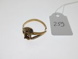 a close up of a gold ring with a tag on it