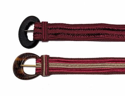 pair of red and brown belts with metal buckles on a white background