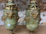two vases that are sitting on a table