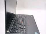 a laptop with a black keyboard sitting on a white surface