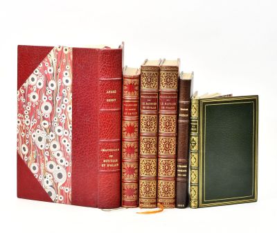 three books sitting next to each other on a white surface