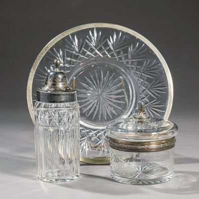 two glass jars and a glass plate on a table