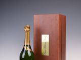 a bottle of champagne in front of a wooden box