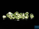 a bunch of green diamonds on a black surface