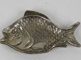 an image of a silver fish shaped object on a white surface