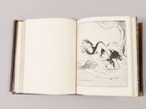 an open book with a drawing of a man and a dog on it
