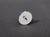 a close up of a small white button on a black surface