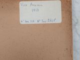 an old envelope with a sticker on it sitting on a marble surface
