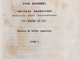 an old book with black writing on it sitting on a table