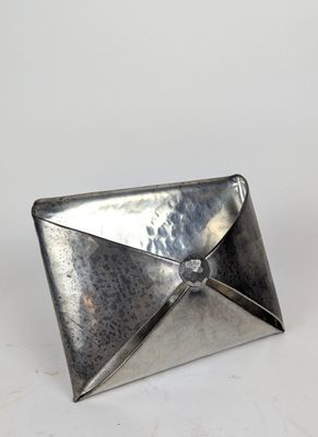 une enveloppe en métal argenté ornée d'un diamant à l'intérieur