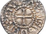 a close up of a coin with a cross on it