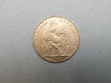 a close up of a gold coin with a rooster on it