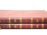 three books are stacked on top of each other on a white surface