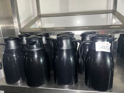 many black vases sitting on a shelf in a kitchen