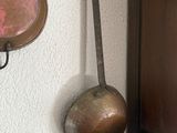 pots and pans hanging on a wall next to a wooden door
