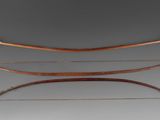 three wooden bows and a bow rest on a gray surface